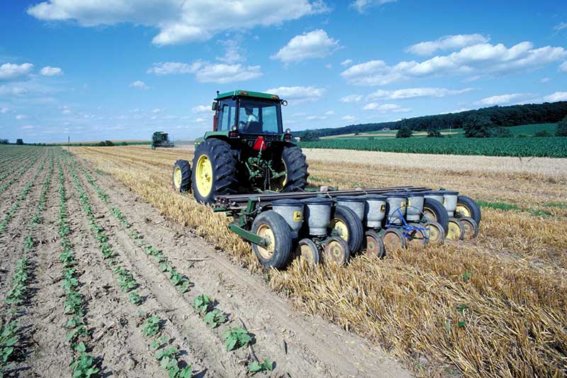 Farmer on a tractor performing conservation tillage. 