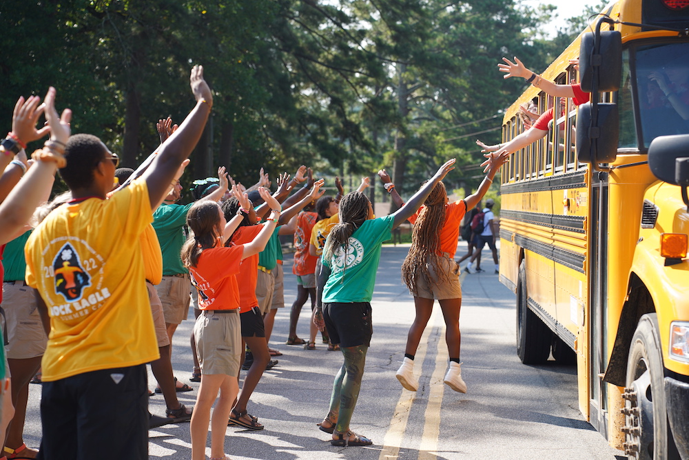 Counselors and campers welcome buses full of newcomers to Georgia 4-H summer camp. 