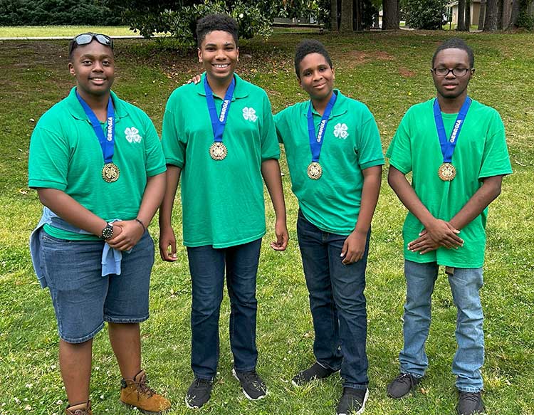 Chatham County senior 4-H wildlife judging team members Derek Wangai, Jason Allman, Jacob Allman and Hayaat Labaran achieved Master 4-H'er status with their first place win.