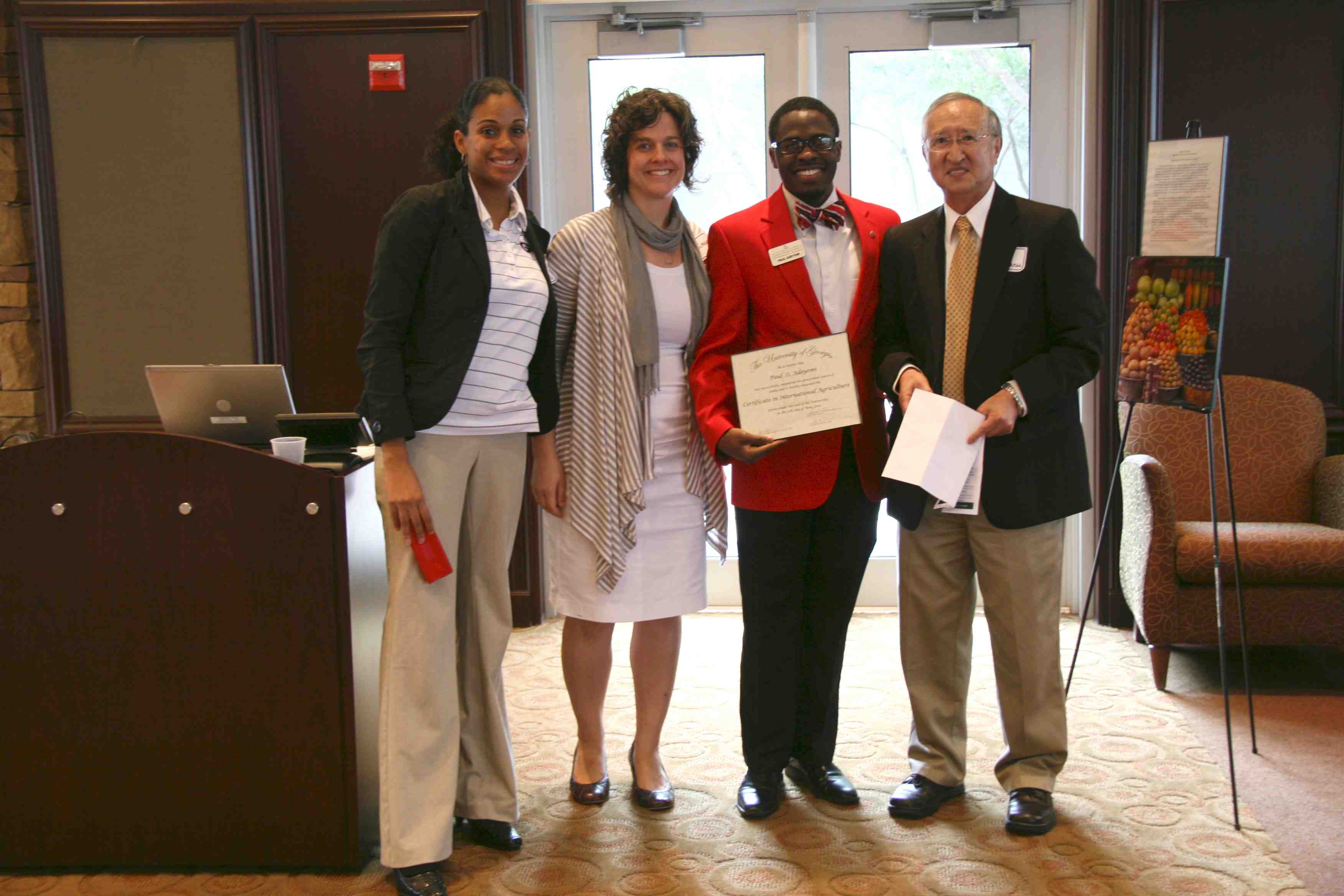Paul Adeyemi receives his certificate of International Agriculture. He was the beneficiary of a $5,000 Arnold International Fellowship, which paid for a study abroad trip to spain last summer, to continue his studies in Latin American this summer and to take part in a service-learning trip this summer.