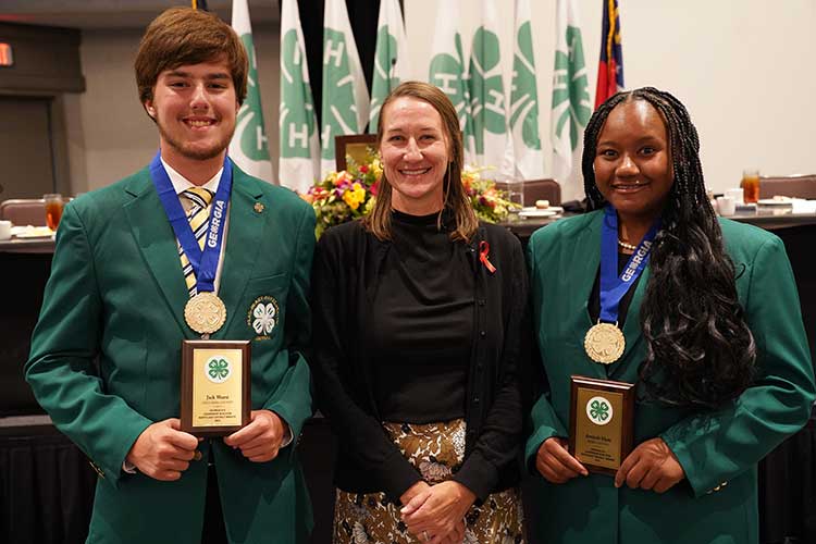 2023 Leadership in Action winners Jack Wurst (left) from Columbia County and Amiyah Elam (right) from Ware County are congratualtied by Georgia 4-H Stat Leader Melanie Biersmith (center).