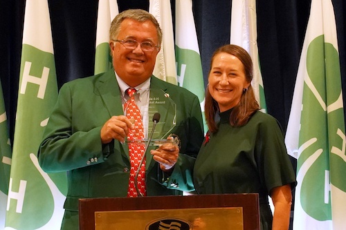 Georgia Representative Rick Jasperse receives the 4-H Green Jacket Award from Melanie Biersmith.