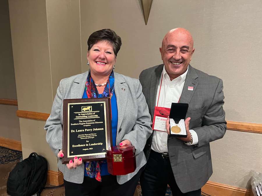 UGA Extension director Laura Perry Johnson (left) and N.C. State Extension director Rich Bonnano smile after accepting their honors at the annual Southern Region Program Leadership Network conference in August.