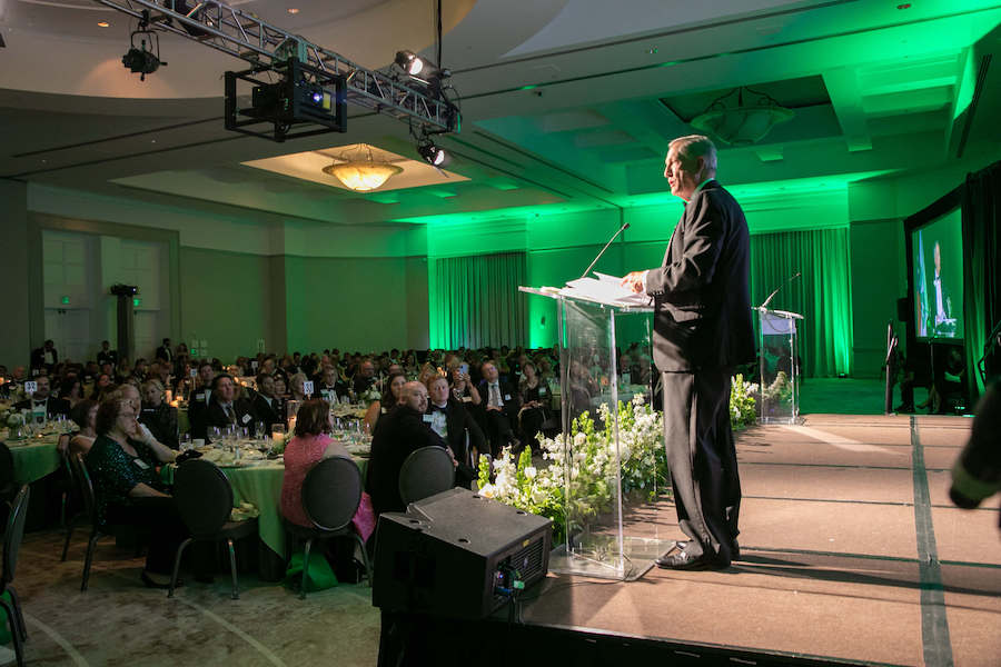 Randy Nuckolls stands at the lectern at the Georgia 4-H gala, where he accepts the Georgia 4-H Lifetime Achievement Award.