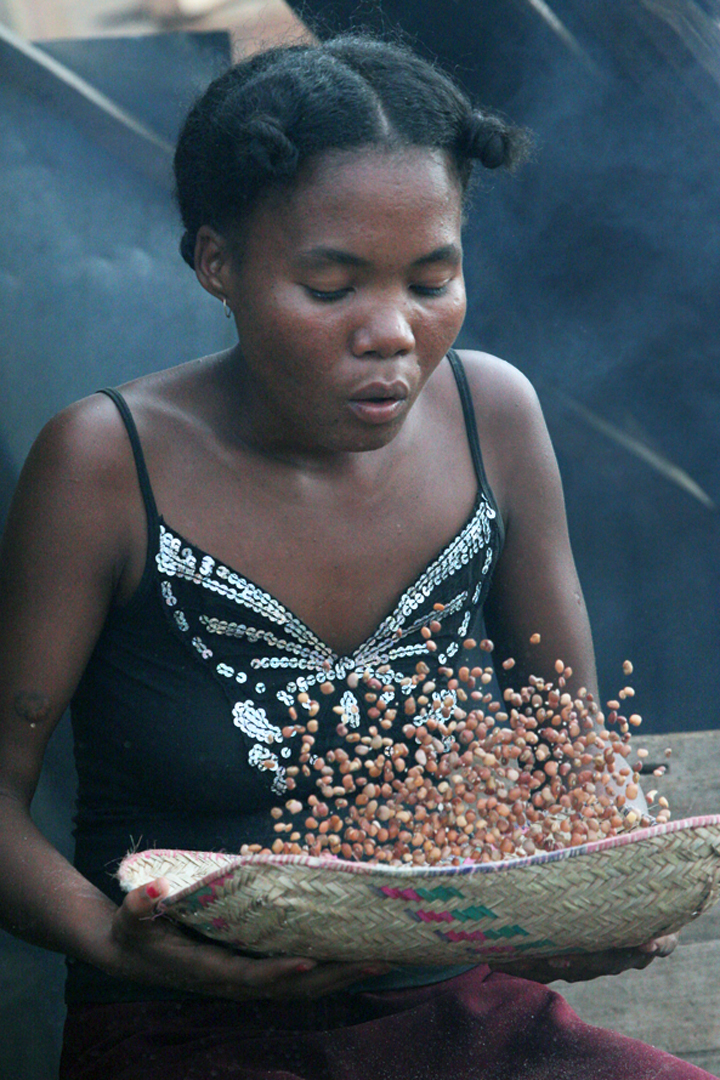 woman winnowing peanuts