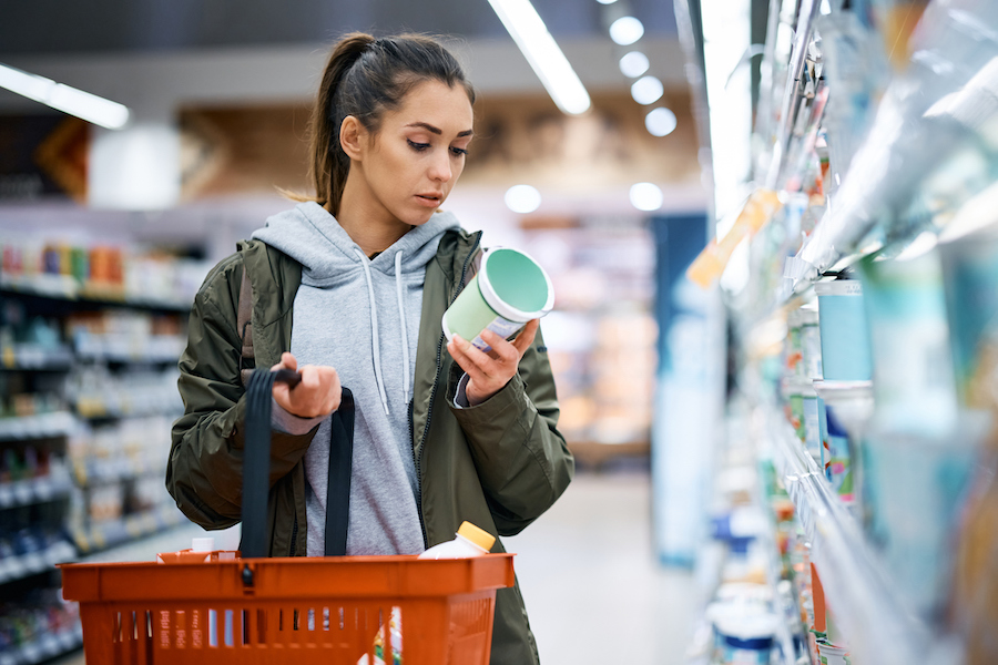 Woman checking yogurt food label