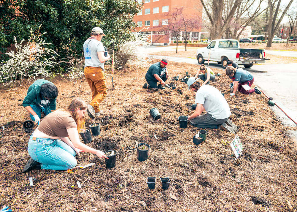 Students in the State Botanical Garden’s Learning by Leading program install a pollinator garden at the Georgia Center for Continuing Education & Hotel. (Photo by Jaime DeRevere)