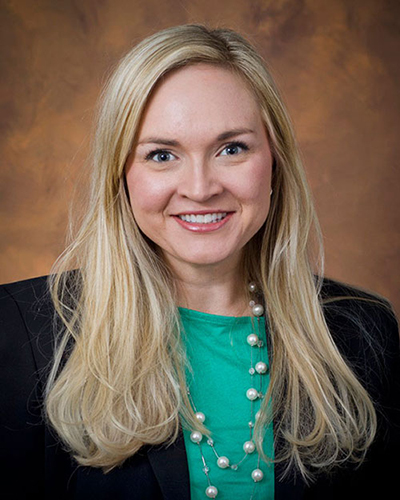 Associate Professor Jessica Holt smiles in her professional headshot