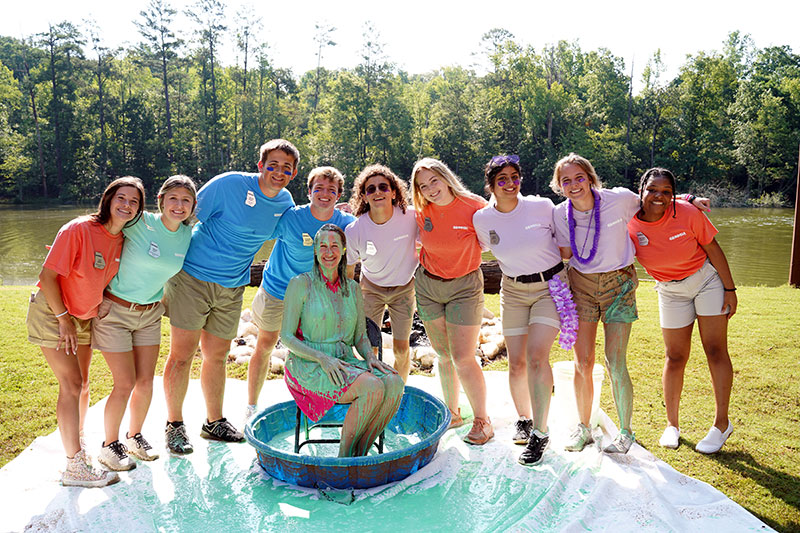 The 2022-2023 Georgia 4-H student board poses with green slime-covered Georgia 4-H Leader Melanie Biersmith after the 2023 $4 for 4-H celebration. Biersmith has agreed to subject herself to the slime again this year if the $74,444 goal is reached.