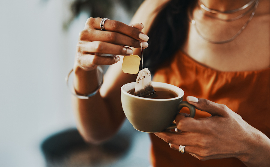 Cropped shot of a woman steeping tea in a mug