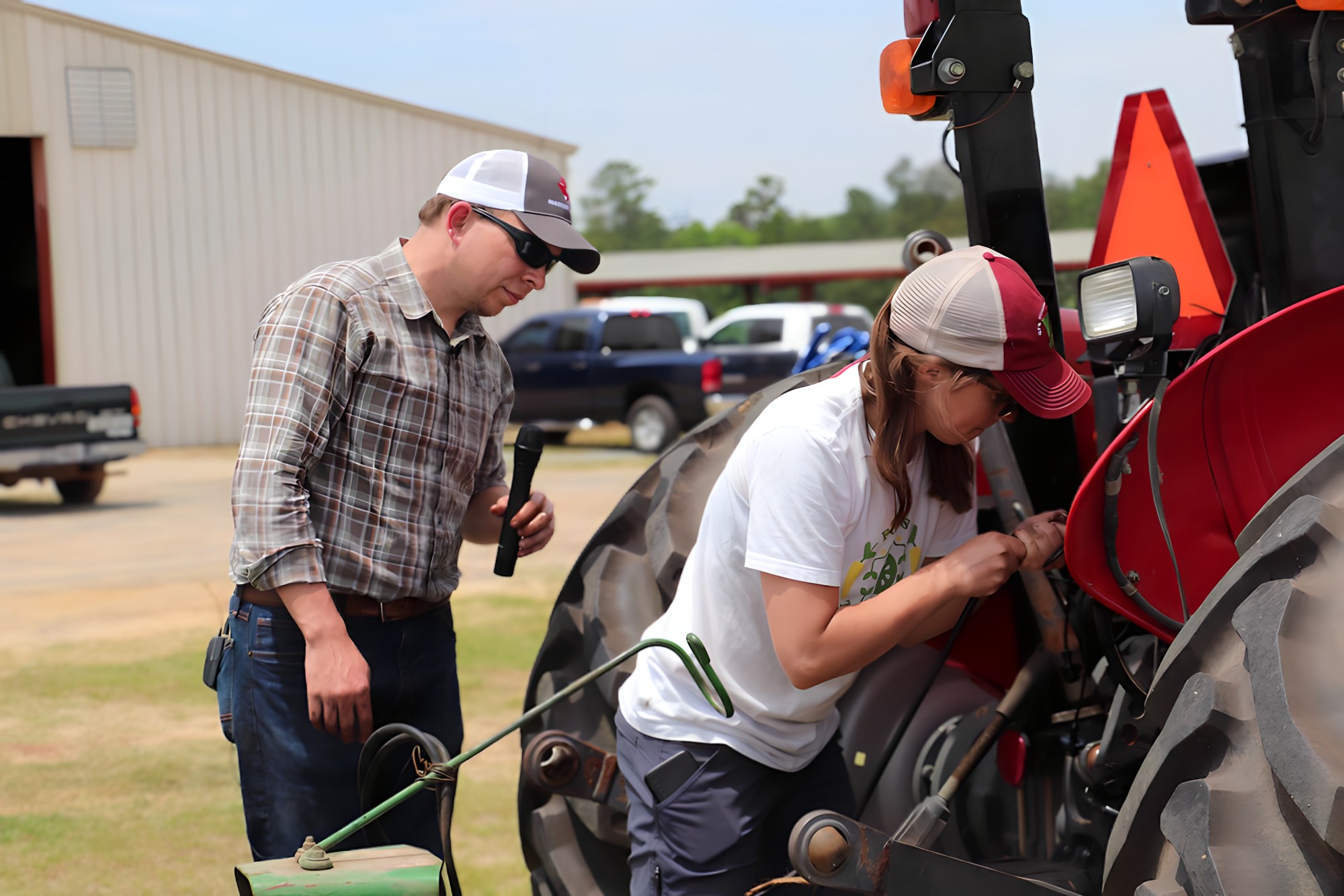 Two people during hands-on tractor safety training workshop