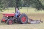 Small farmer James Cobb mows a field in Butts County, Ga.