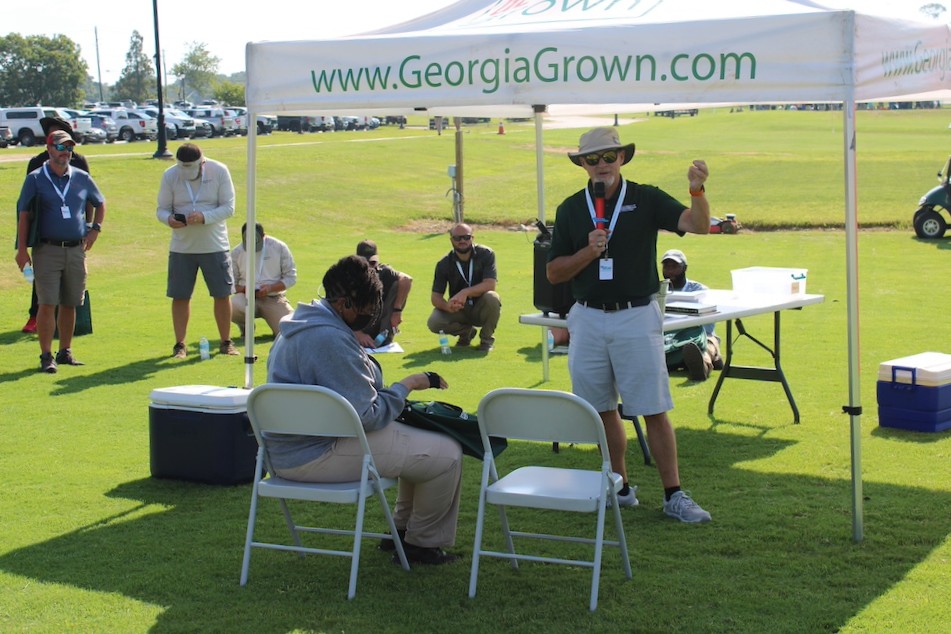 Clint Waltz speaks to a crowd from under a Georgia Grown tent