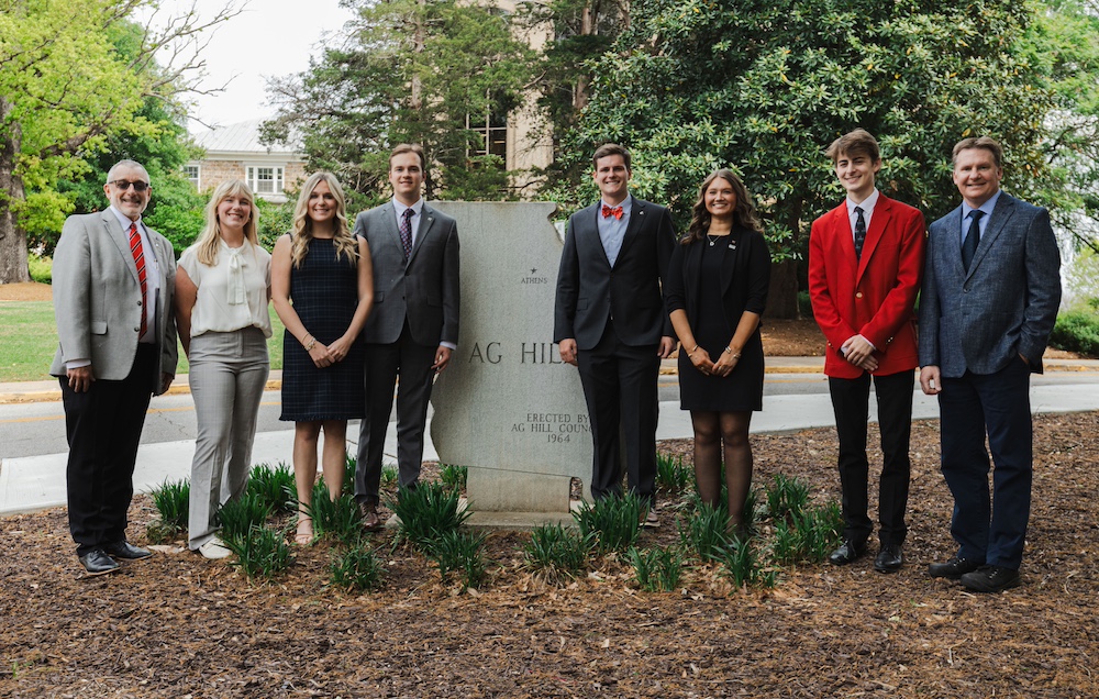 The Congressional Ag Fellows pose with CAES administration at the Ag Hill marker on UGA's South Campus.