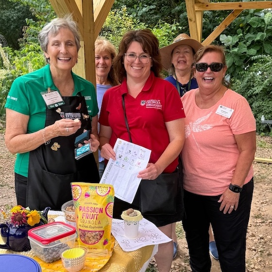 State Master Gardener Coordinator Sheri Dorn poses with Master Gardeners and the 2024 Open Garden Days Passport